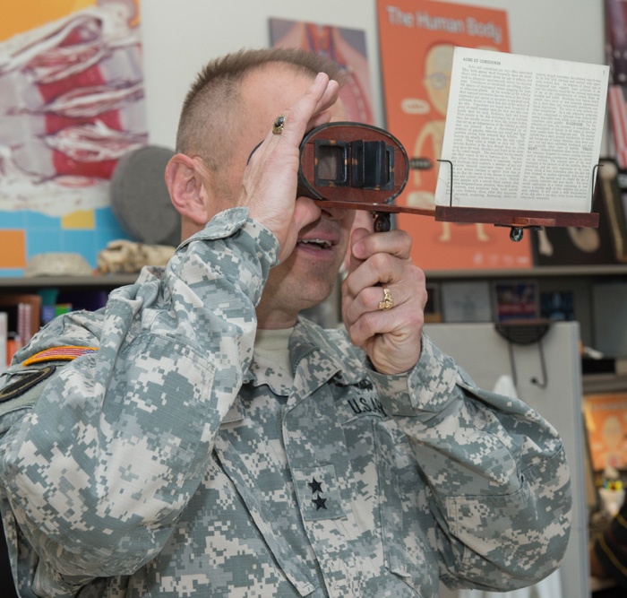 Maj. Gen. Brian Lein views a stereoscopic medical illustration