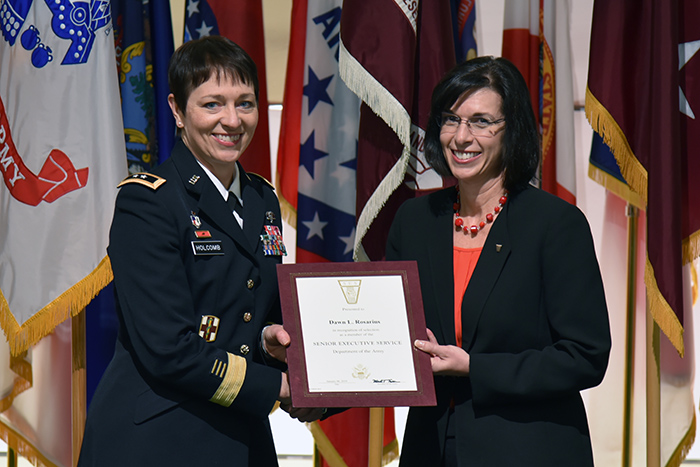 Gen. Barbara R. Holcomb, left, presents a recognition certificate to Dawn Rosarius