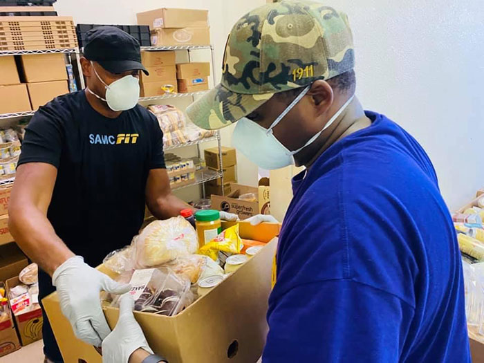 CSM Rodmond Churchill (left) volunteers his time during a recent food drive