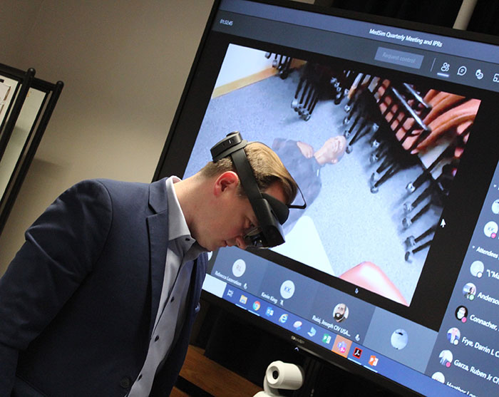 A volunteer views a virtual reality patient 