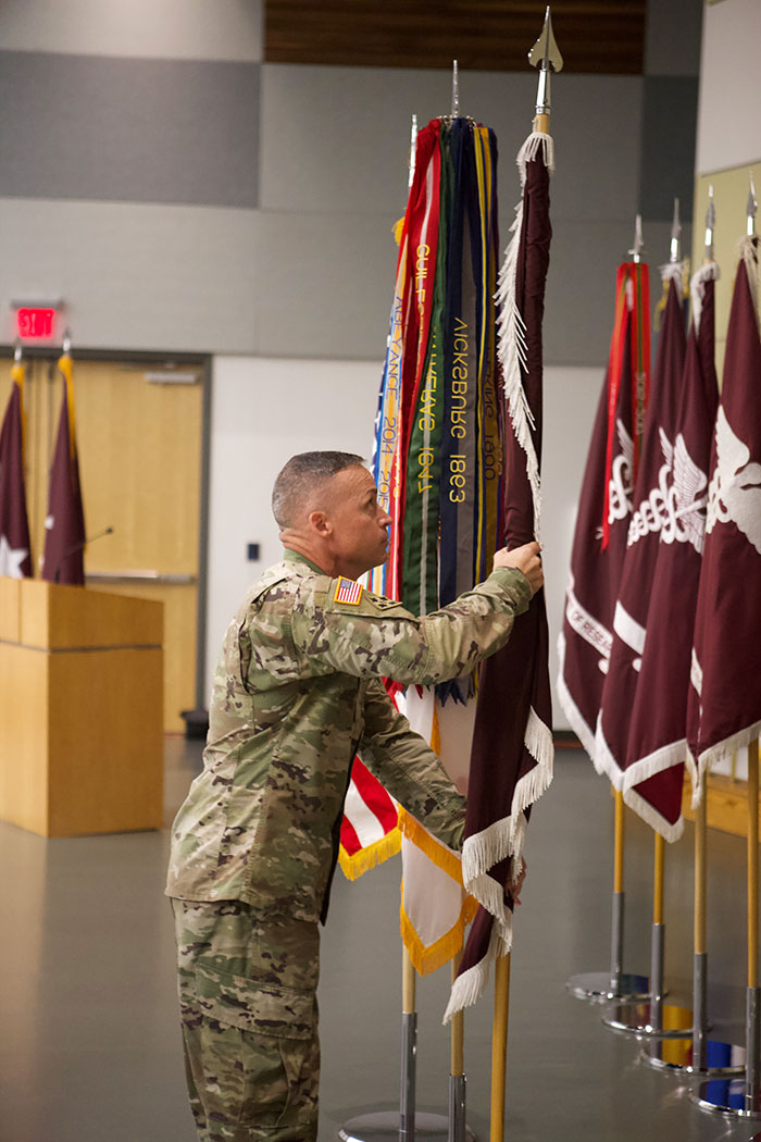 Command Sgt. Maj. Dills holds a flag