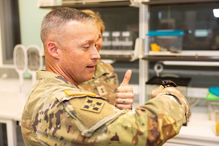 Command Sgt. Maj. Dills holds an insect model