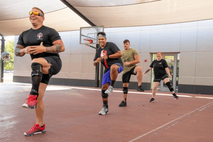Soldiers work out with cuff and ankle support device