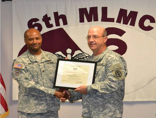 Col. Michael J. Talley, commander of the 6MLMC, accepts one of four awards by Maj. Gen. James K. Gilman, USAMRMC commander.