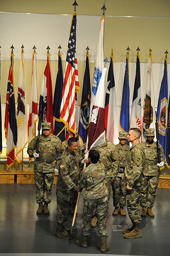 Col. David L. Sloniker accepts the colors from Maj. Gen. Barbara R. Holcomb