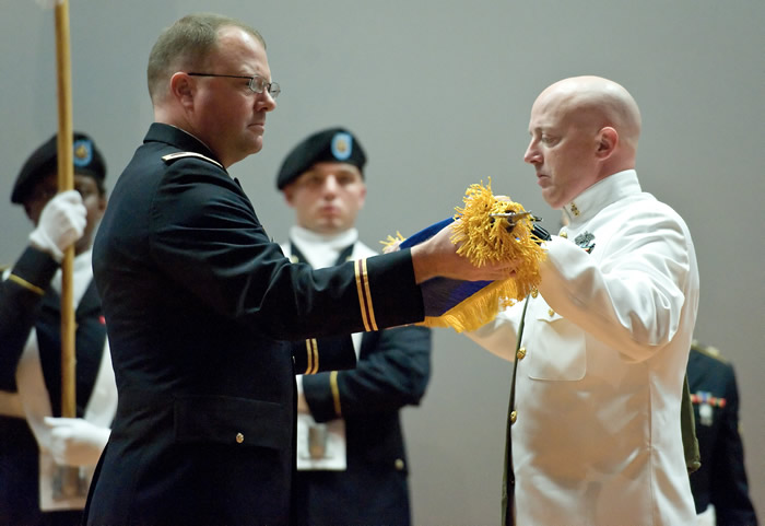 Col. Ladd Tremaine, left, and U.S. Navy Senior Chief Petty Officer Stanley Travioli, right, case the AFMES colors