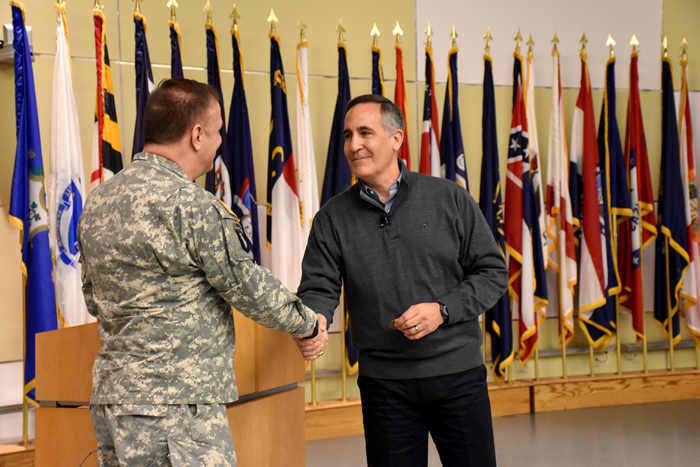 Col. William Geesey presented Col. Arthur Athens with the USAMMDA command coin