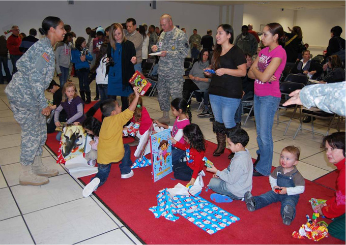 Children at the U.S. Army Medical Materiel Center, Europe receive presents from Soldiers and staff members