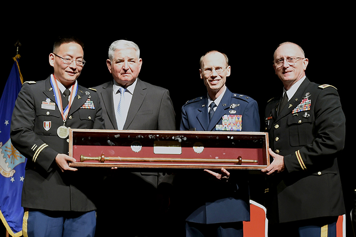 Lt. Col. (Dr.) Kevin K. Chung, left, is presented the Golden Headed Cane Award
