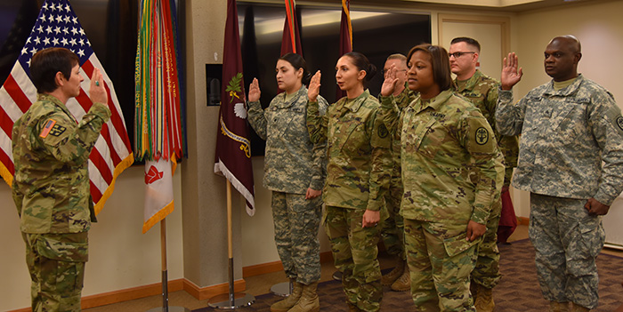 Maj. Gen. Barbara R. Holcomb presides over a mass re-enlistment of Soldiers