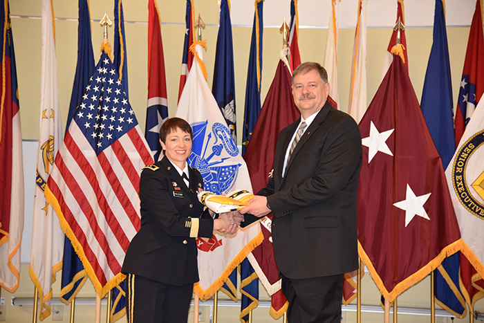 Maj. Gen. Barbara R. Holcomb presents Dr. George Ludwig with his Senior Executive Service Flag