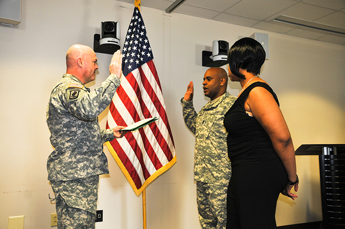 Master Sgt. Melvin D. Milton, with his wife Nitikka, reenlists in the U.S. Army