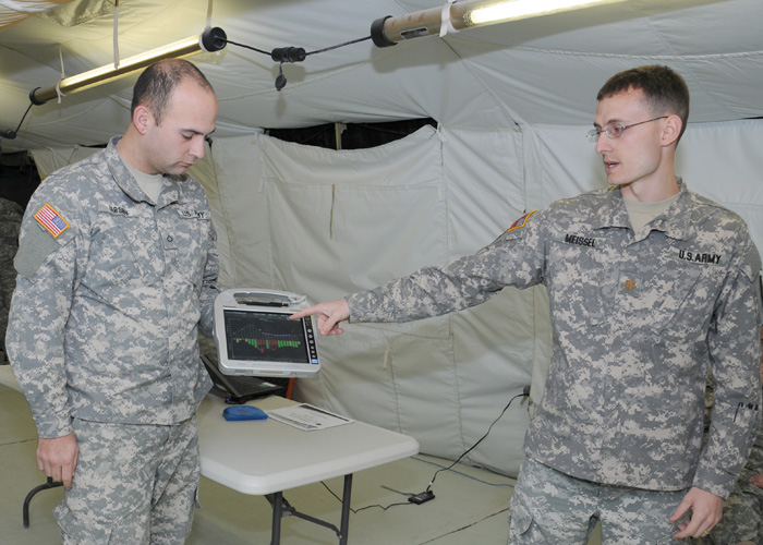 Maj. Michael Meissel demonstrates Burn Navigator features to Pfc. Christopher Larsen at Fort Hood, Texas.