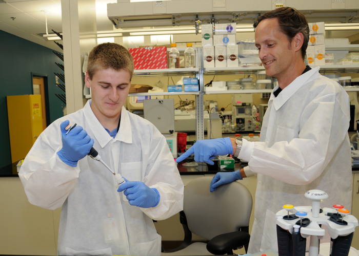 Summer intern Sean Christy and microbiologist Lloyd Rose, Ph.D.