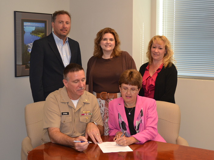 U.S. Navy Capt. Keith Syring and Dr. Theresa Alban sign an Education Partnership Agreement