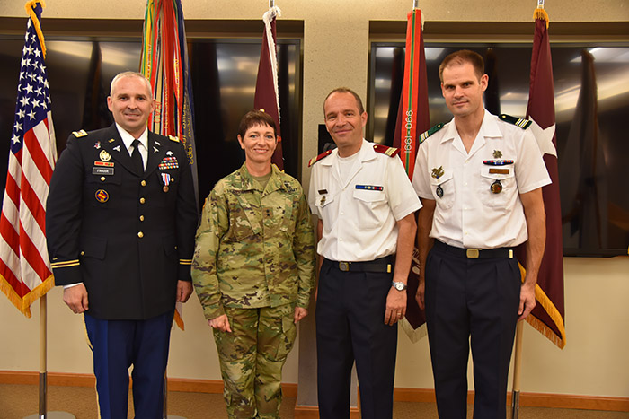 Maj. Gen. Barbara R. Holcomb joins Maj. Jeffrey Froude and representatives of the French Army Biomedical Institute