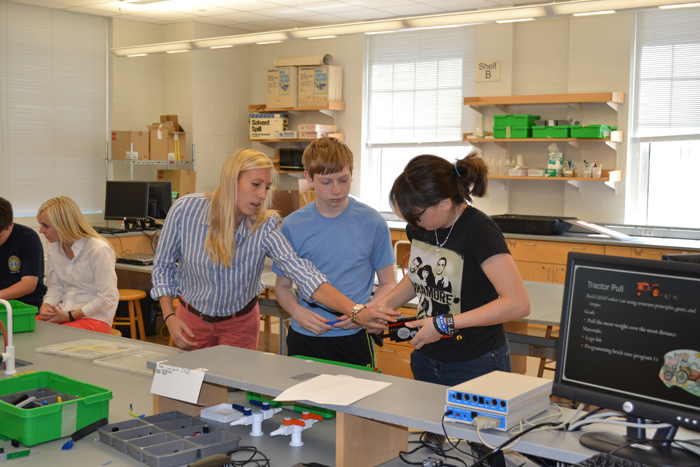 Paige Eckard guides students during a robotics class
