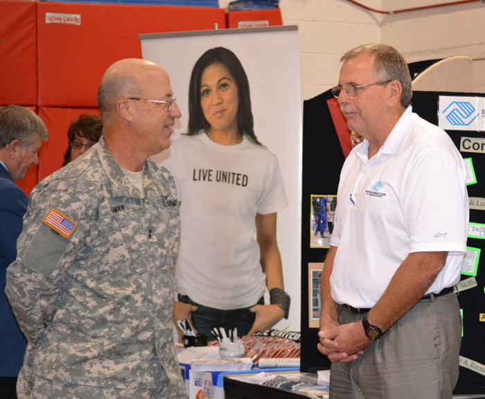 Maj. Gen. James K. Gilman, commanding general of the USAMRMC, speaks with a representative from the Boys & Girls Club of America