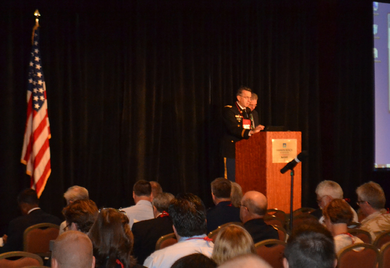 Col. Dallas Hack welcomes attendees to the 2012 Military Health System Research Symposium in Fort Lauderdale, Fla.