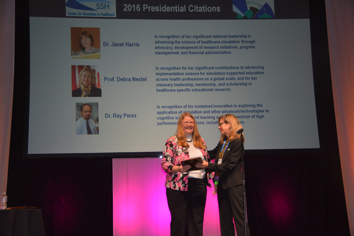 Dr. Janet Harris receives an award from Dr. Pamela Andreatta