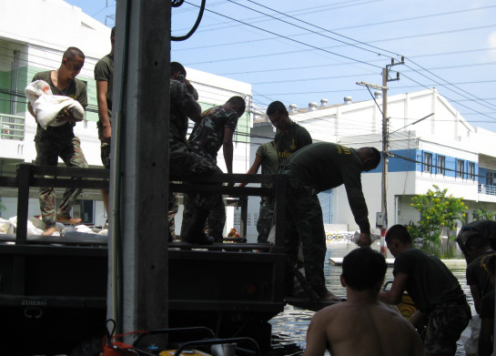AFRIMS staff work together to hold back the rising waters in Bangkok, Thailand