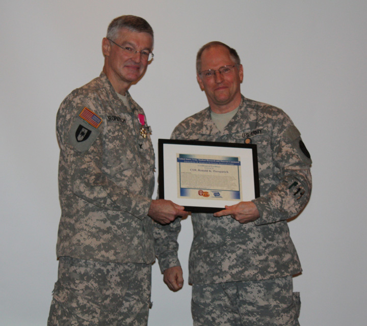 Col. Karl Friedl, TATRC commander presents retired Col. Ron Poropatich TATRC's Award for Excellence in Telemedicine.
