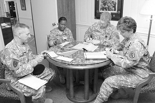 James Shaheen, Plans and Operations Specialist for the Logistics Readiness Center, completes his contribution form for the Combined Federal Campaign with the other respective Fort Detrick command teams