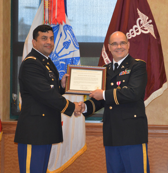Col. Stephen Dalal presents retired Lt. Col. Travis Watson with a certificate of appreciation.