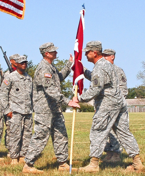 Col. Bruce A. Schoneboom receives the unit flag from Maj. Gen. James Gilman