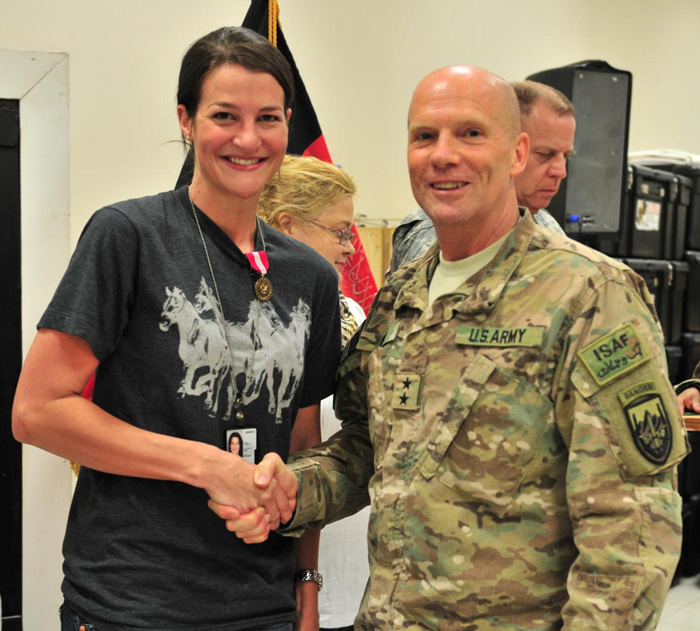 Maj. Gen. Kenneth Dahl, U.S. Forces-Afghanistan deputy commanding general for Support, congratulates Mary Profitt.