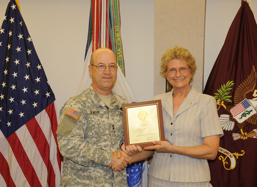 Maj. Gen. James K. Gilman, USAMRMC commanding general, presents Ellen Santaliz with a Length of Service Award