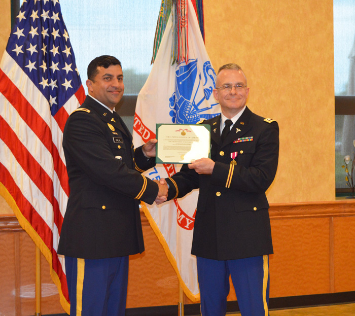 Col. Stephen Dalal presents the Meritorious Service Medal to retired Lt. Col. David Shoemaker