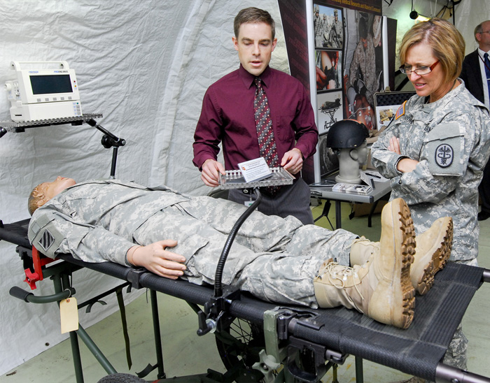 Lt. Gen. Patricia D. Horoho talks with Alan Harner about a Mini-Special Medical Emergency Evacuation Device