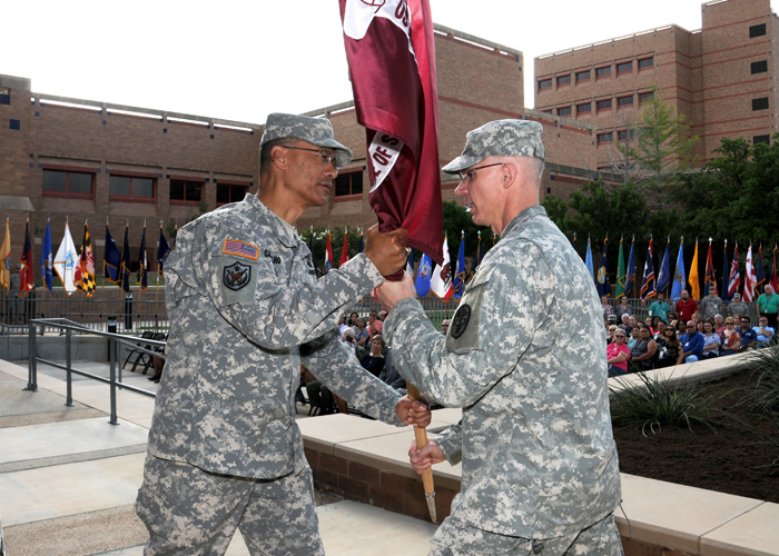 Maj. Gen. Joseph Caravalho Jr. presents the USAISR's flag to Col. Michael D. Wirt II