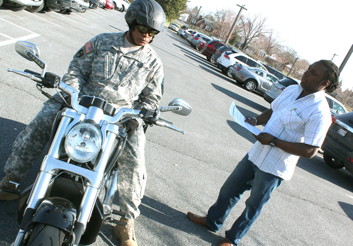 Wendell Johnson completes a motorcycle safety inspection with Greg Pugh