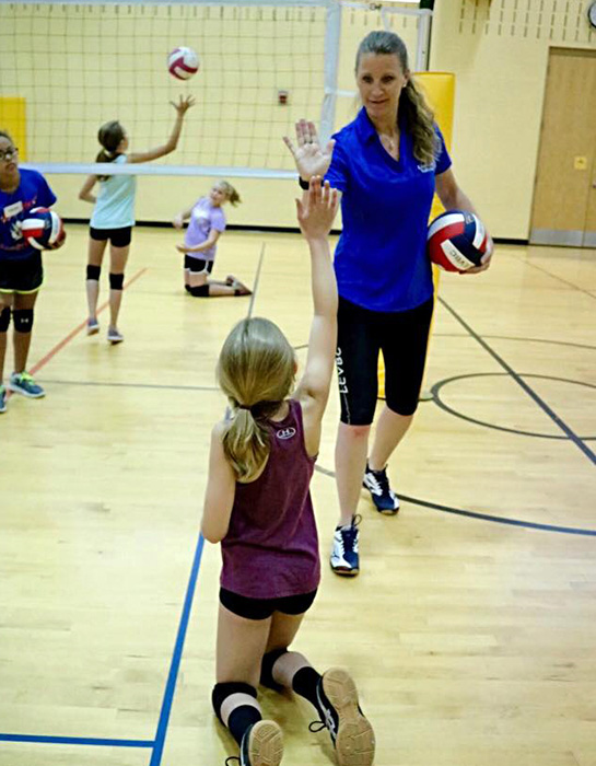 Terri Pryor encourages a young volleyball player