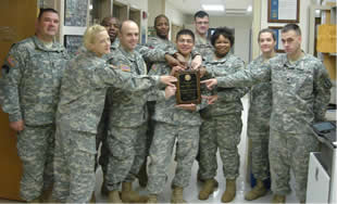 Soldiers at the U.S. Army Institute of Surgical Research proudly surround their award.