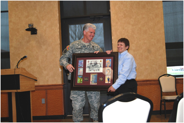Col. Russell E. Coleman presenting a gift of appreciation to guest speaker Dr. Connie Devilbiss