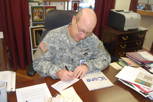 MG James Gilman filling out his Combined Federal Campaign pledge form