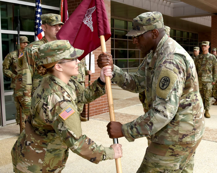 First Sgt. Brittney Graham takes guidon from Capt. Cleveland Bryant Jr.