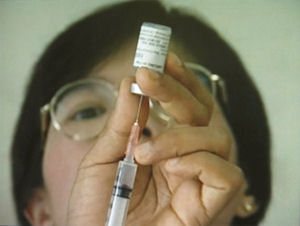 Syringe with vaccine bottle