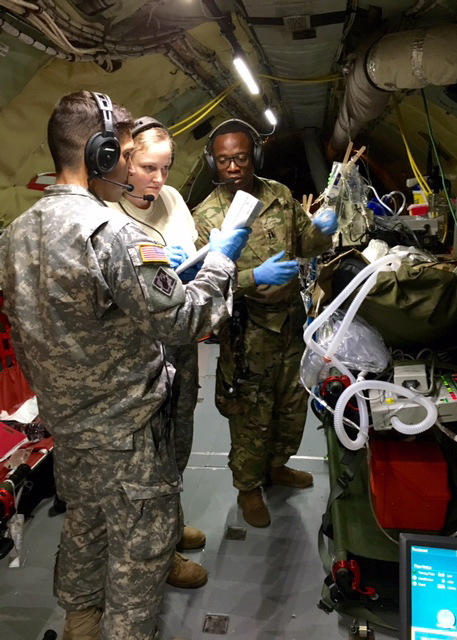 USAISR Burn Flight Team members monitor a patient