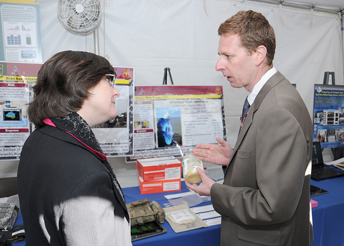 USAMRMC's Combat Casualty Care Research Program Deputy Director Dr. David Baer talks with a visitor