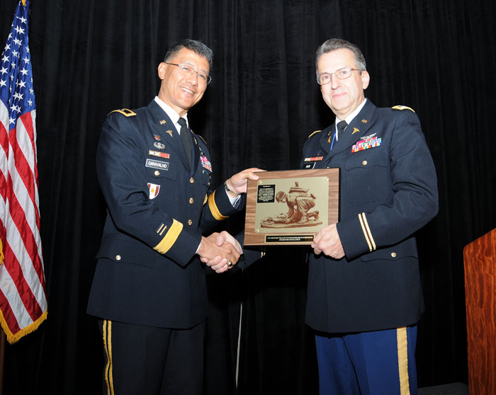Combat Casualty Care Research Program Director Col. Dallas Hack received a plaque at the Military Health System Research Symposium