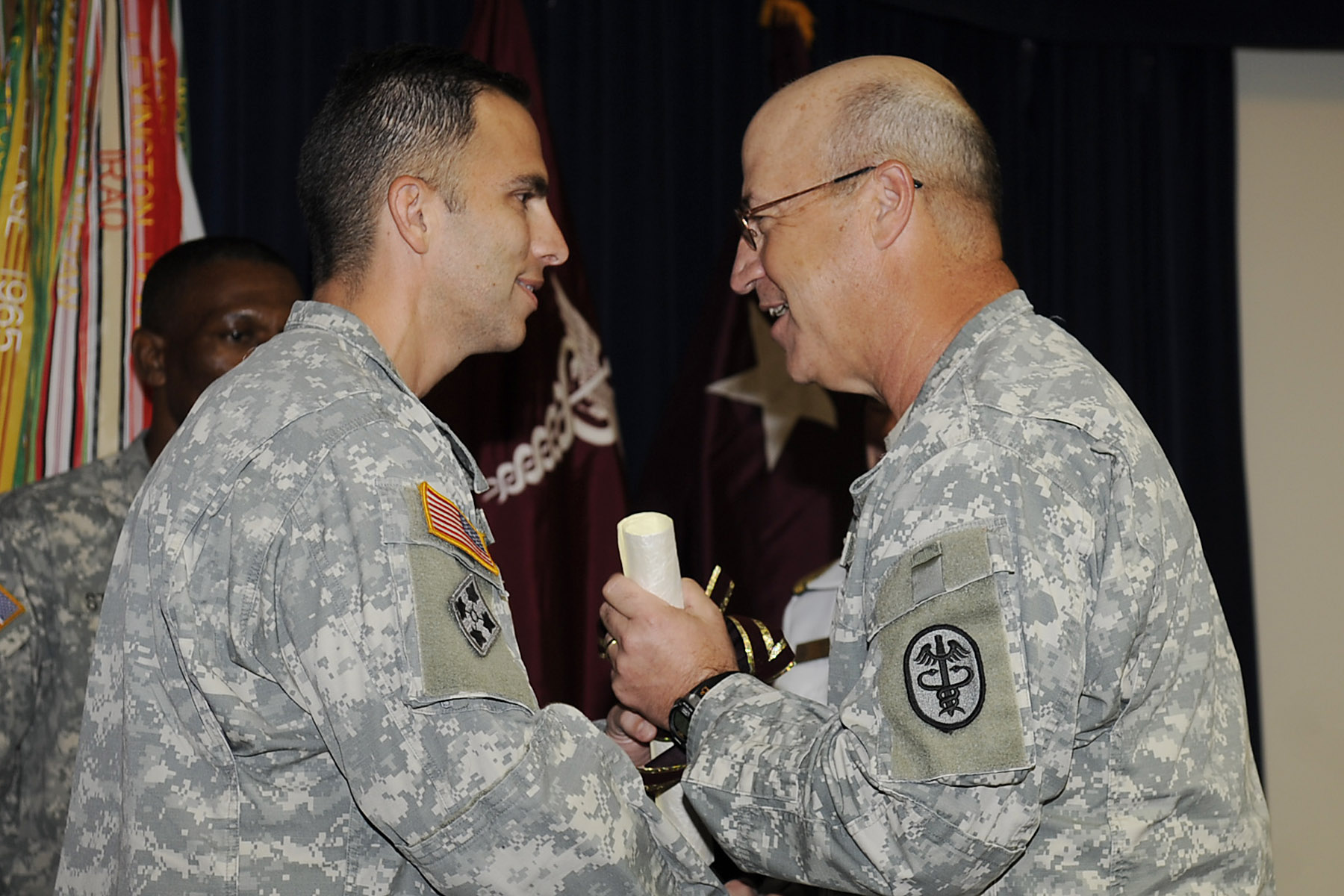 Maj. Gen. James Gilman, commanding general of the U.S. Army Medical Research and Materiel Command congratulates Lt. Col. (P) Jeffrey Leggit, new director of CDMRP
