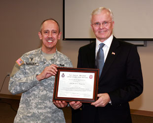 Chaplain (Lt. Col.) Jeffrey Giannola gives Chaplain  (Brig. Gen.) Douglas E. Lee a certificate of appreciation for being the guest speaker at the Post Prayer Breakfast, Jan. 20 at the new Community Activity Center, located at 1520 A.