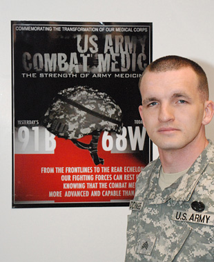 Sgt. Christopher Giddinge of the U.S. Army Medical Research Institute of Infectious Diseases stands by his winning poster